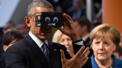 Barack Obama and Angela Merkel test virtual reality glasses during the president's visit to Germany