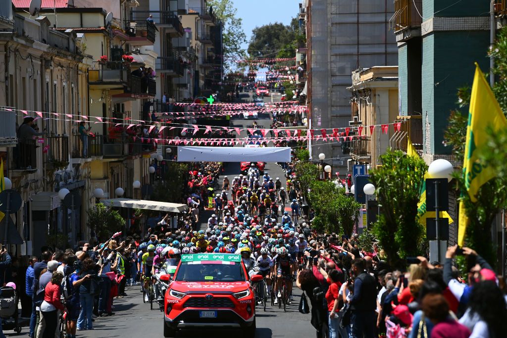 SCALEA ITALY MAY 12 A general view of the peloton passing through Palmi City while fans cheer prior to the 105th Giro dItalia 2022 Stage 6 a 192km stage from Palmi to Scalea Giro WorldTour on May 12 2022 in Scalea Italy Photo by Tim de WaeleGetty Images