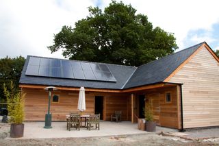solar panels on the roof of a timber home