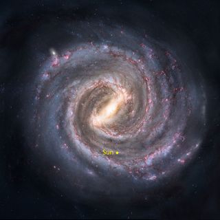 This artist's conception of our home, the Milky Way, viewed from above, illustrates how the galaxy's spiral arms abound with pinkish concentrations of glowing hydrogen gas where star clusters are being created.
