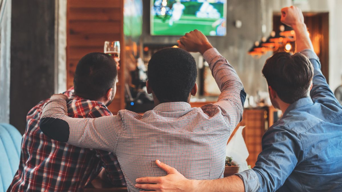 Watching sports on TV in a bar