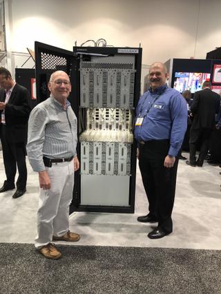 At the 2018 NAB Show, KVIE director of engineering Mike Cappi (L) and Hitachi-Comark VP of engineering Tom Barbeau check out  a VHF Parallax transmitter.   