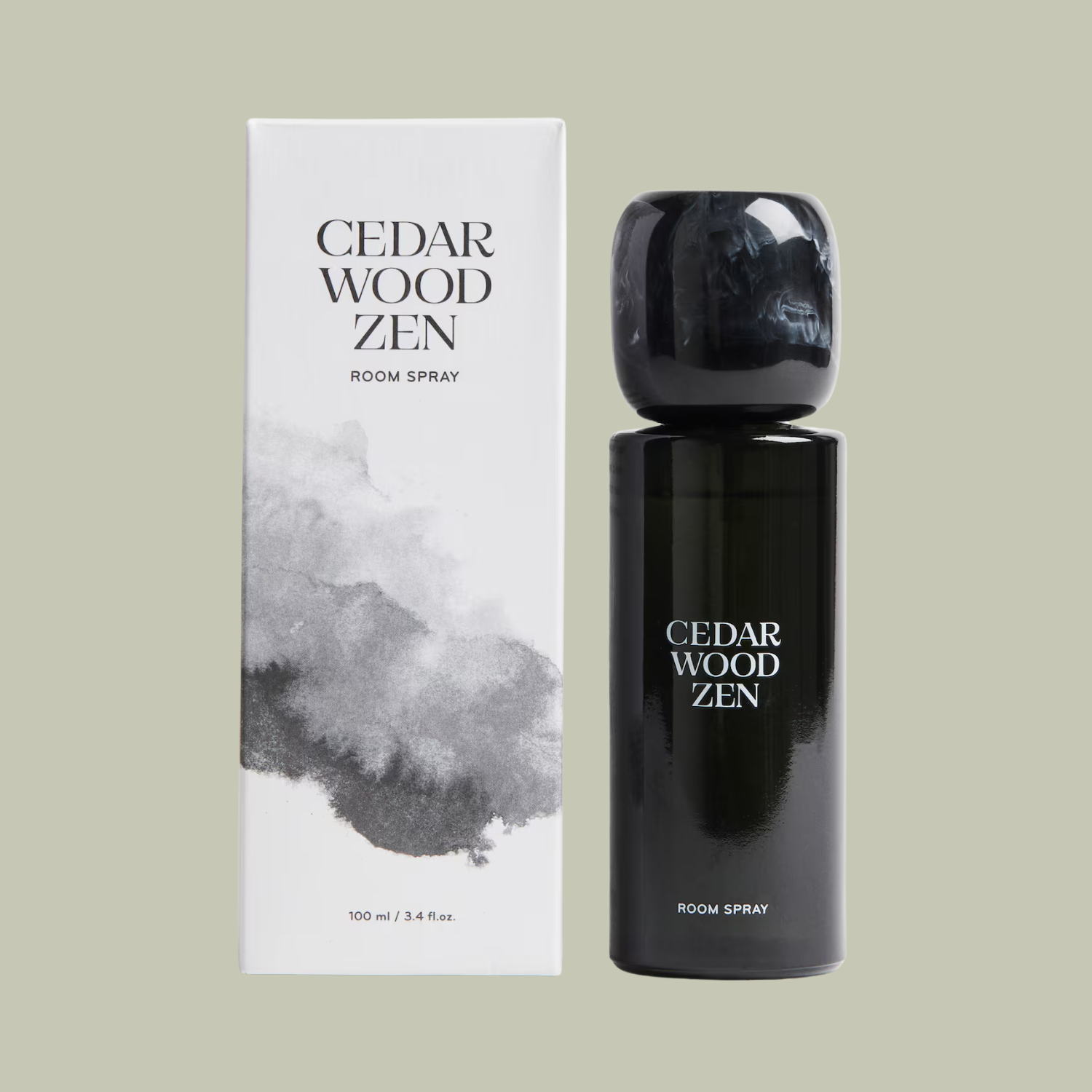 A glass room spray beside a box