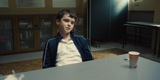 owen cooper as jamie sitting in the interrogation room in a still from adolescence