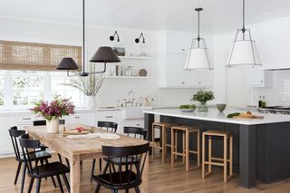 white kitchen with pendant lighting and wall sconces by Katie Hodges Design