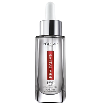 a bottle of loreal serum in front of a plain backdrop