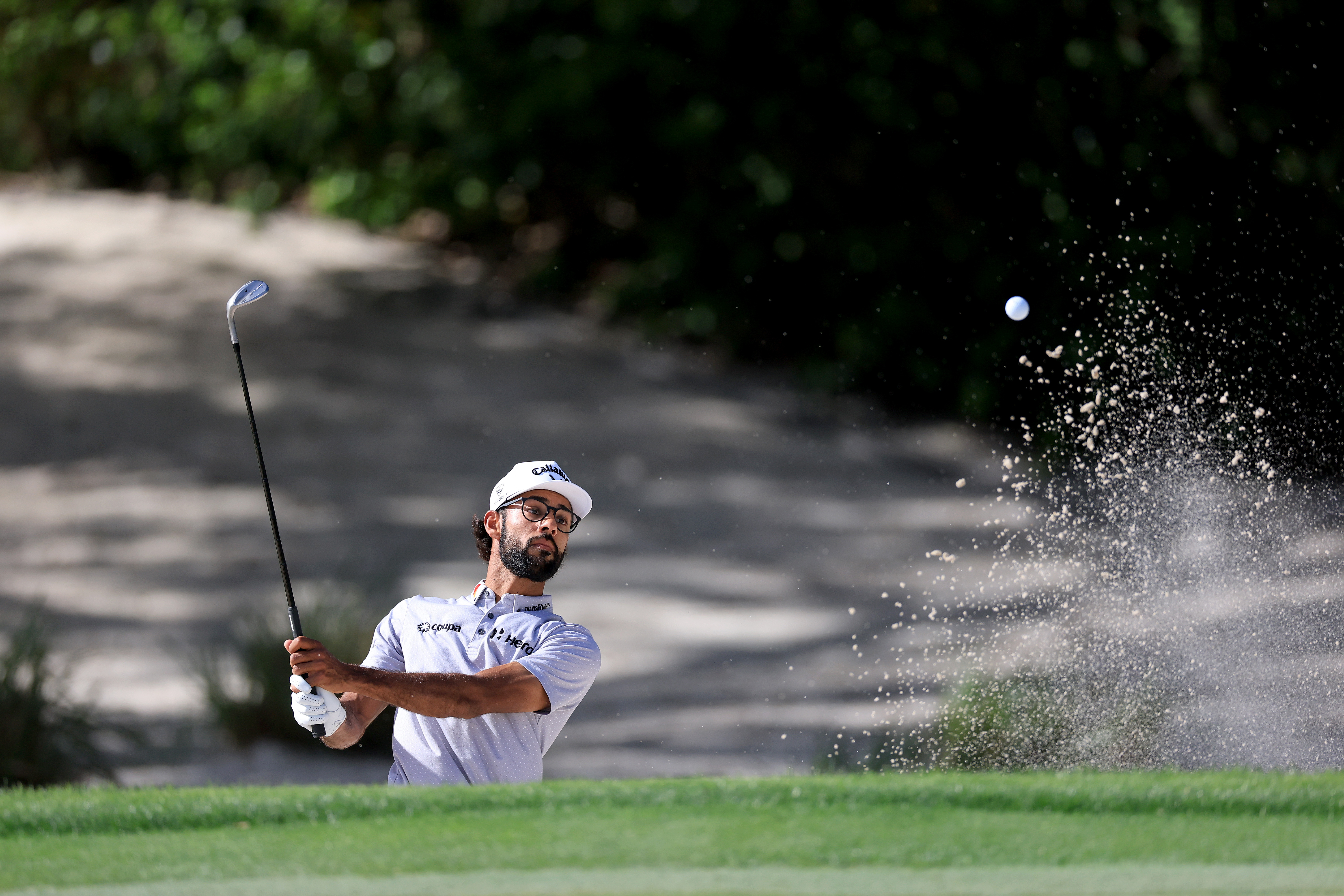Akshay Bhatia hits a bunker shot