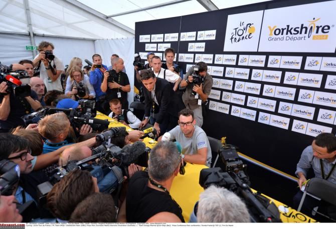 Mark Cavendish surrounded by microphones