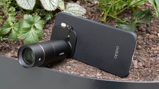 Oppo Find X9 Pro phone with a Hasselblad teleconverter lens attached