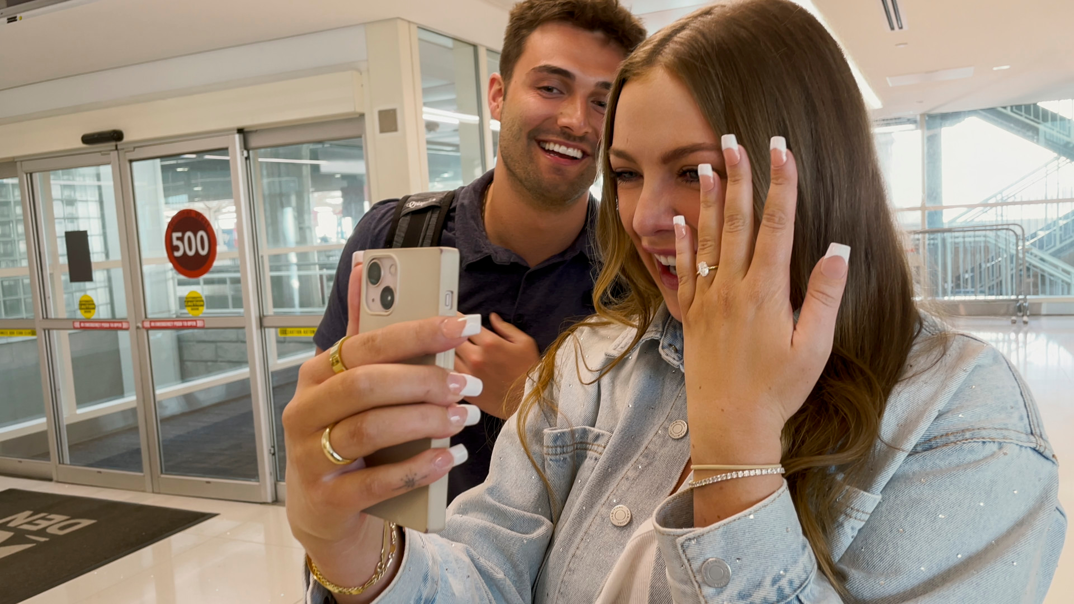 madison shows off her engagement ring while joe smiles taking a photo in love is blind season 9