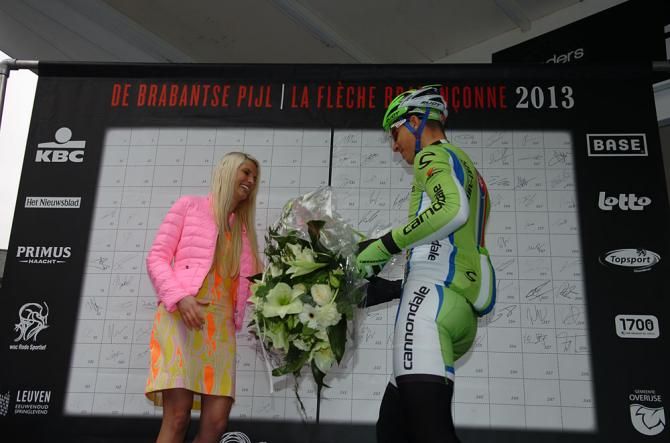 Peter Sagan (Cannondale) presents flowers to say he's sorry for pinching this podium girl's behind