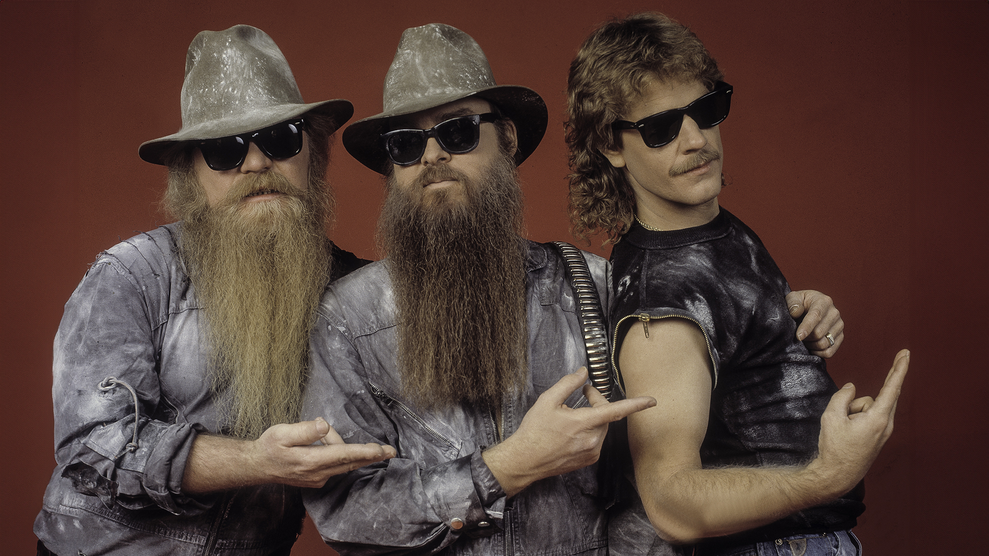 Portrait of members of the American Rock group ZZ Top as they pose backstage at the Metro Center, Rockford, Illinois, February 8, 1984. Pictured are, from left, Dusty Hill, Billy Gibbons, and Frank Beard.