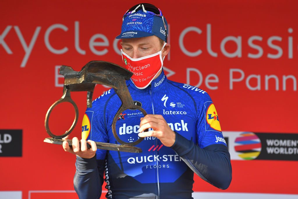 DE PANNE BELGIUM MARCH 24 Podium Sam Bennett of Ireland and Team Deceuninck QuickStep Celebration during the 45th Oxyclean Brugge De Panne 2021 Men Classic a 2039km race from Brugge to De Panne Trophy Mask Covid Safety Measures OxycleanClassic on March 24 2021 in De Panne Belgium Photo by Luc ClaessenGetty Images
