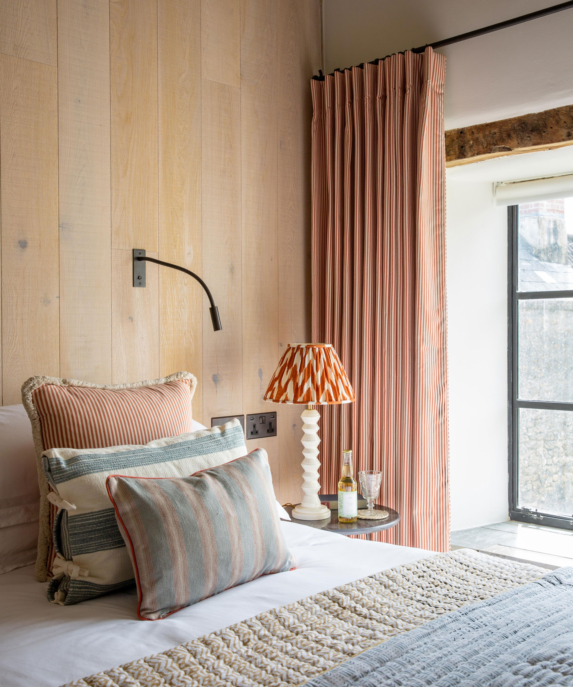 loft bedroom with wooden wall panelling