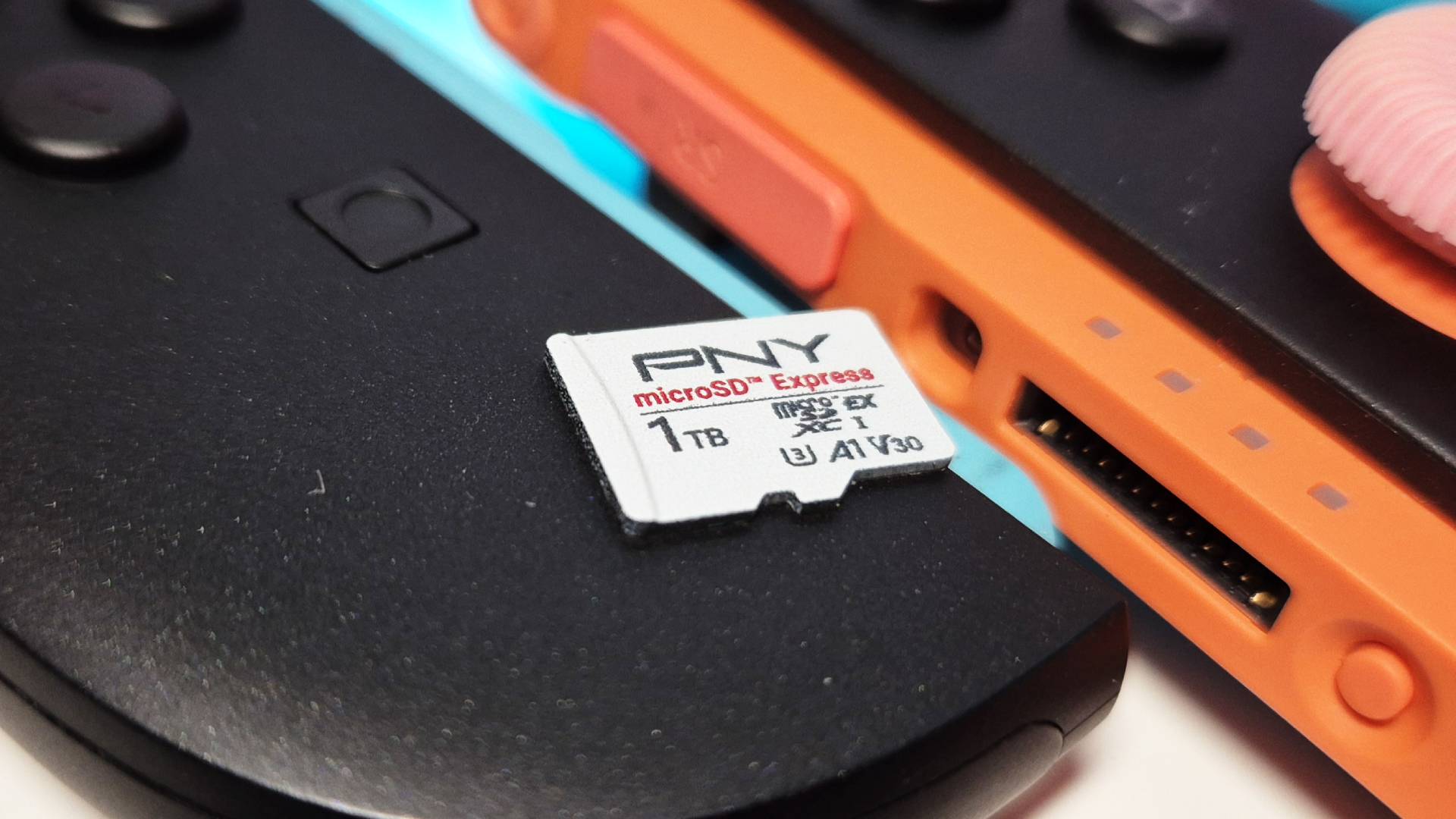 Photo of the 1TB PNY microSD Express Card sitting on a pair of Switch 2 Joy-Cons.