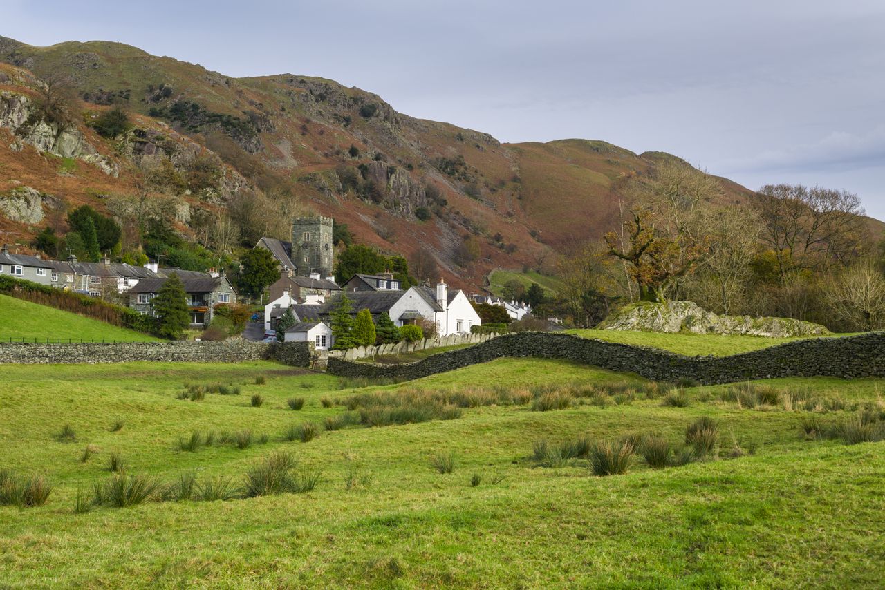 Rolling green fields with a church 