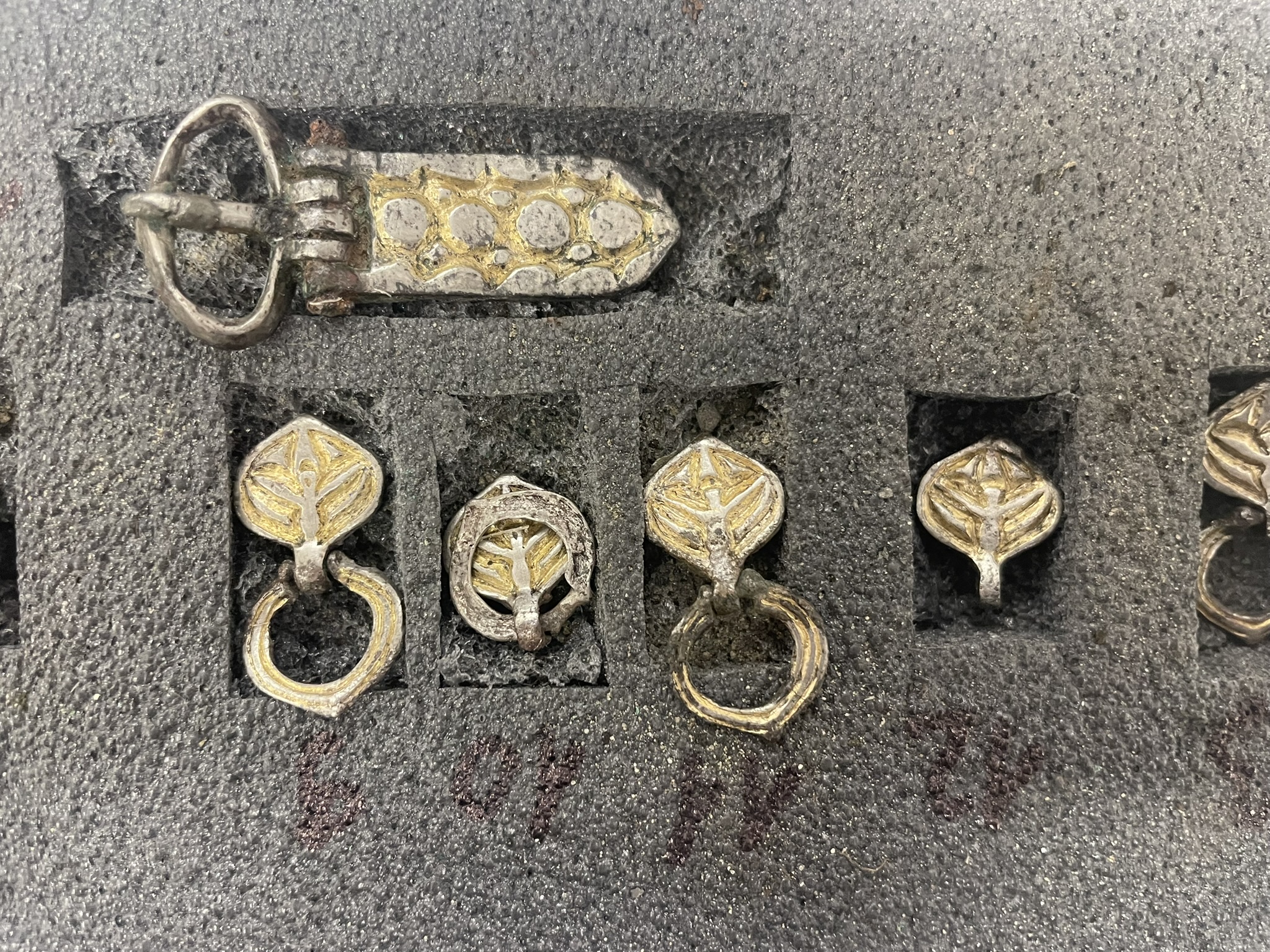 Six different belt mounts and buckles that are silver and gold