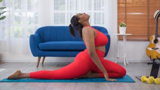 Can yoga help you lose weight: Image shows woman practicing yoga at home