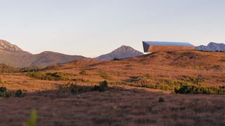 Earth's Black Box resting cantilever on a Tasmanian hill in the middle distance