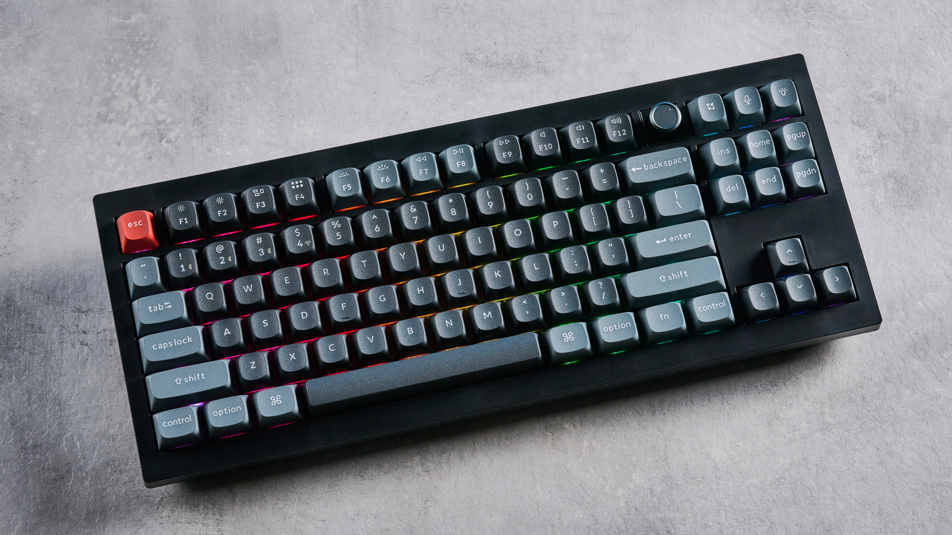 Keychron V3 Ultra 8K photographed on a grey table top in front of a blue background