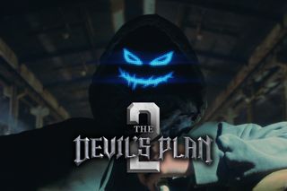 A man wears a hoodie in a menacing LED smiley mask while standing in a warehouse, in a teaser image for 'The Devil's Plan 2.'