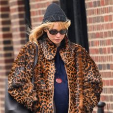 Jennifer Lawrence wears a leopard print coat with weatherproof boots while walking in New York City. 