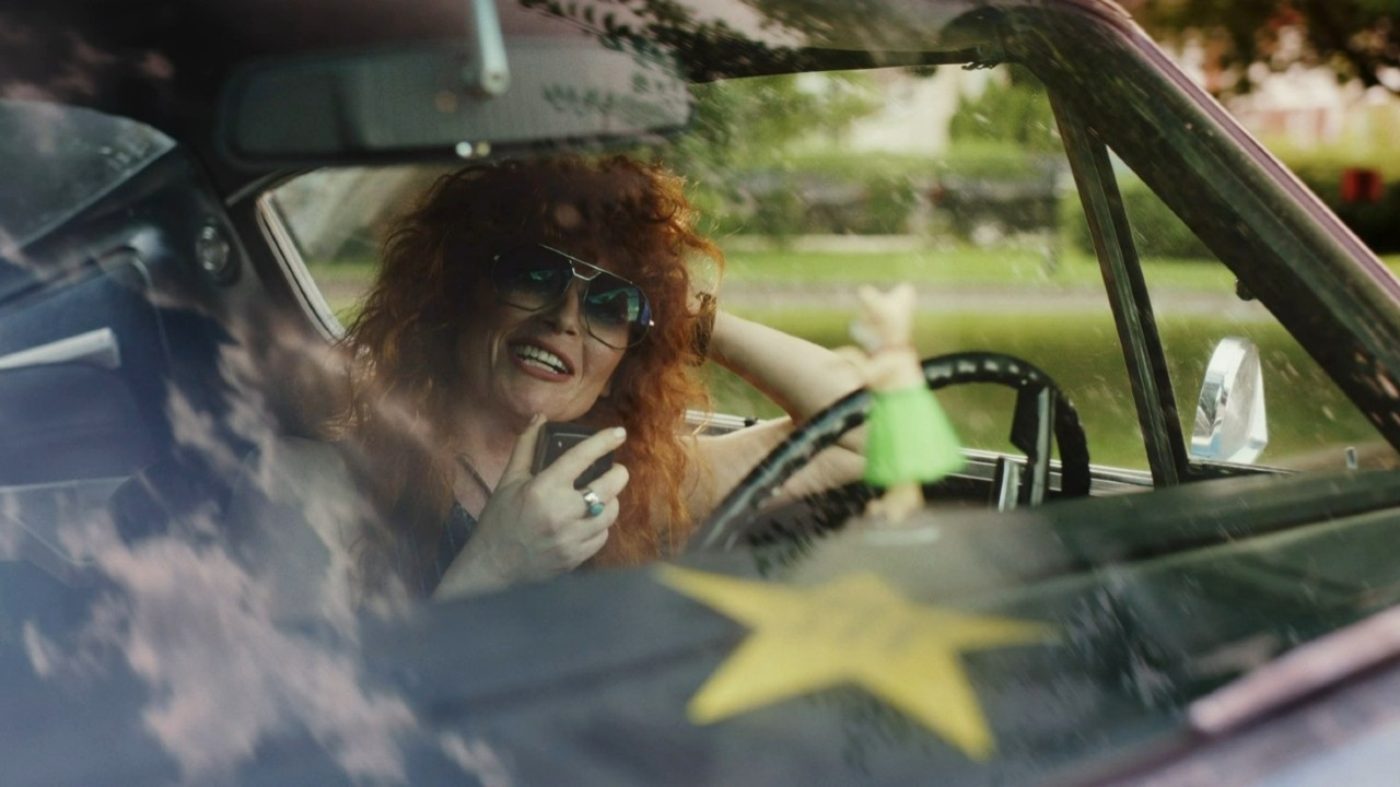 Natasha Lyonne on a phone in a car on Poker Face.
