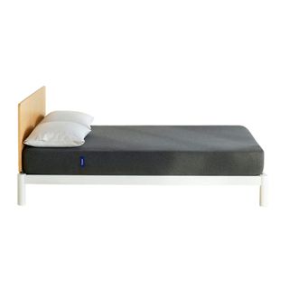 Casper Snug mattress on whtie bed frame with pillows on