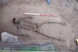 Archaeologists think the remains may be of a seaman who drowned and floated at sea before being washed up on the islet.