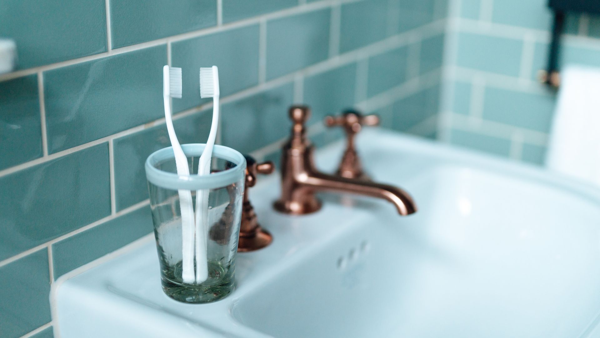 toothbrushes on bathroom sink