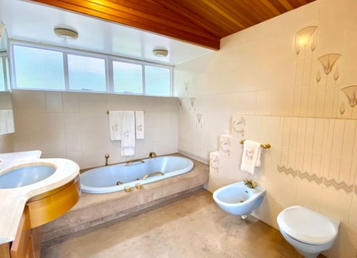 Built in bath with toilet and bidet makes up the bathroom of this 1960s self build property