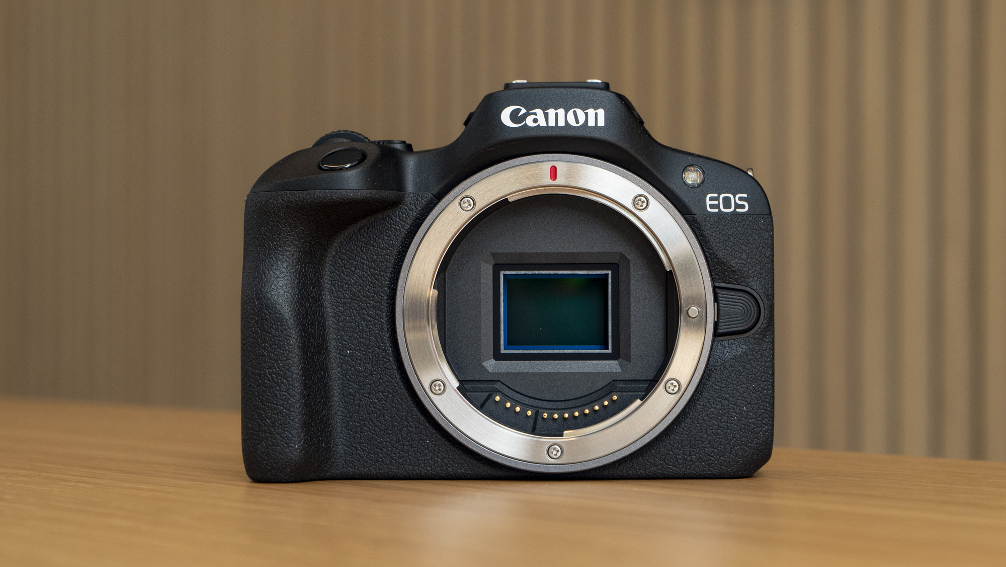 Canon EOS R100 camera on table