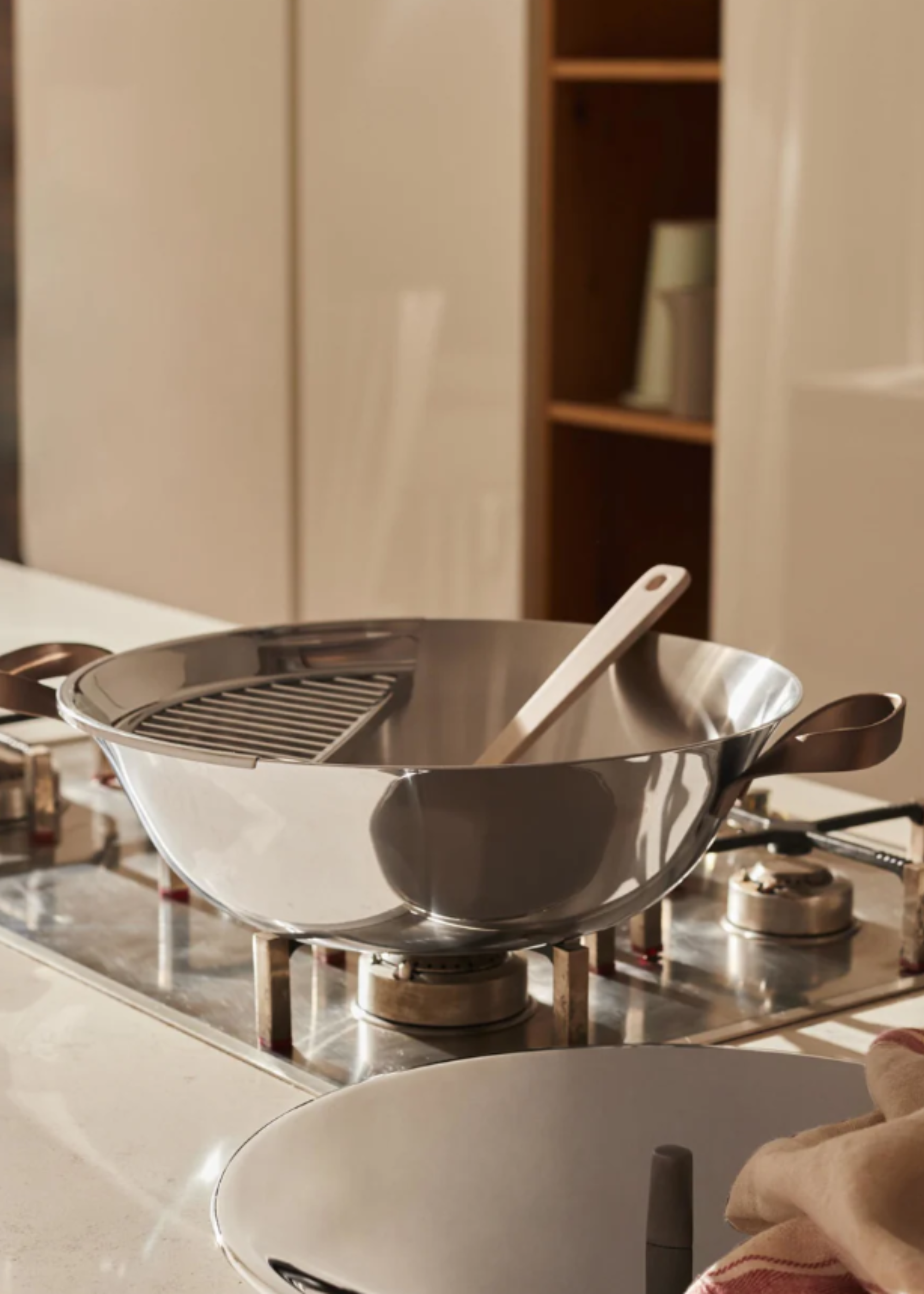 A stainless steel wok on a stove