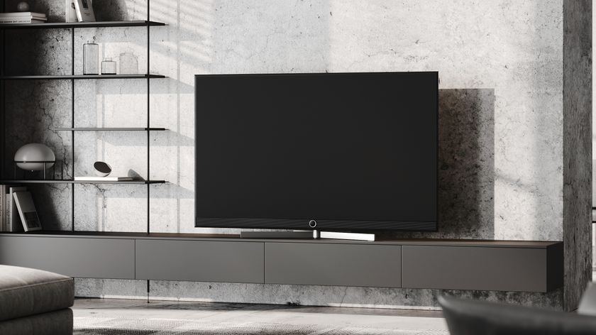 A Loewe stellar alu black + lava TV on a TV cabinet in a premium-looking lounge.