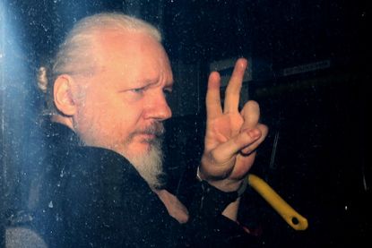 Julian Assange with police