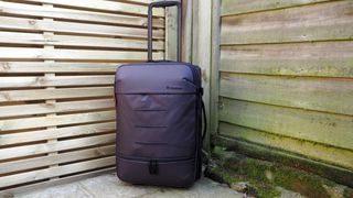 Manfrotto Manhattan Runner 50 camera bag outside in front of a wooden fence