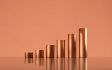 Copper tubes forming a growing bar graph, copy space. Commodity supercycle concept