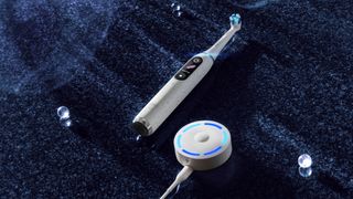 Oral-B iO10 electric toothbrush on cloth surface