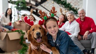 A family christmas morning featuring a golden retriever