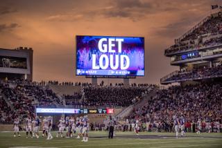 Kansas State University stadium during football game and big screen saying "Get Loud"