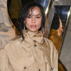 Zoë Kravitz wears a buttoned up trench coat at a Saint Laurent event in Paris