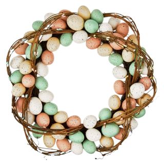 An Easter egg wreath with yellow, white, peach, and mint colored eggs around it, as well as twine wrapped around it