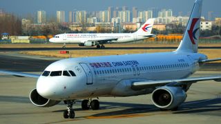 A China Eastern Airlines passenger plane taxies at the airport and the runway at Liuting Airport in Qingdao, east China's Shandong province, Feb 21, 2021.