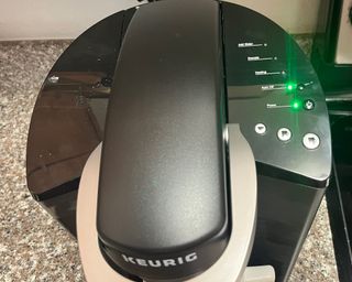 A close-up shot of the Keurig K-Classic coffee maker demonstrating Auto-off functionality