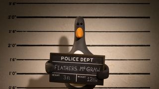 Penguin character Feathers McGraw holding up a sign for a police line-up in "Wallace & Gromit: Vengeance Most Fowl" on Netflix