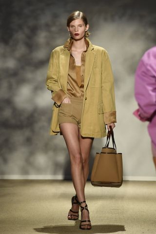 Max Mara S/S 24 runway show. Model wears yellow and brown colour combination.