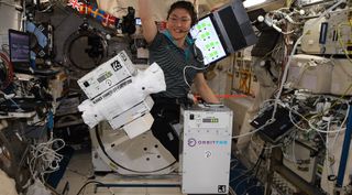 NASA astronaut Christina Koch monitors a satellite refueling experiment called Furphy on the ISS developed by startup company Orbit Fab.