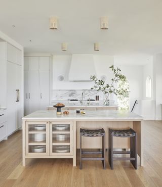 A kitchen with wood and leather stools