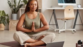 Woman doing yoga meditation at home