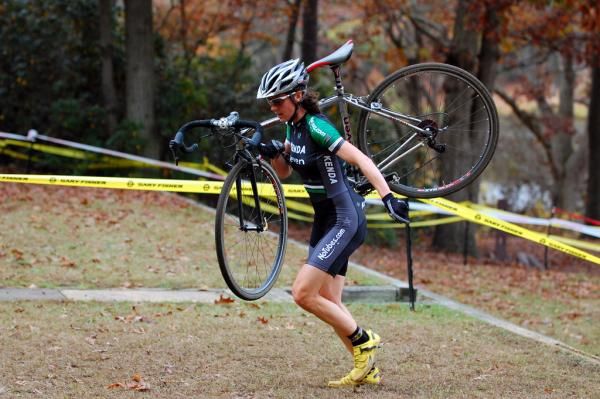 Mary McConneloug runs with her bike.